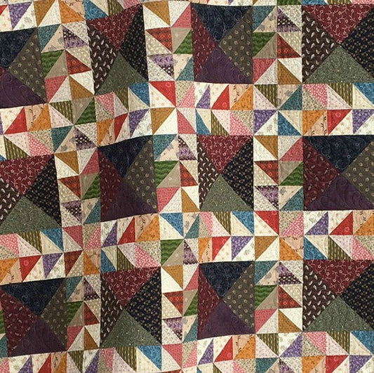 Scrappy lap quilt pattern designed by Deanne Eisenman for Snuggles Quilts