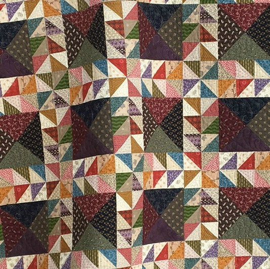 Scrappy lap quilt pattern designed by Deanne Eisenman for Snuggles Quilts