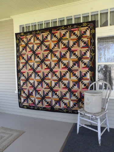 scrappy lap quilt pattern with floral applique accent