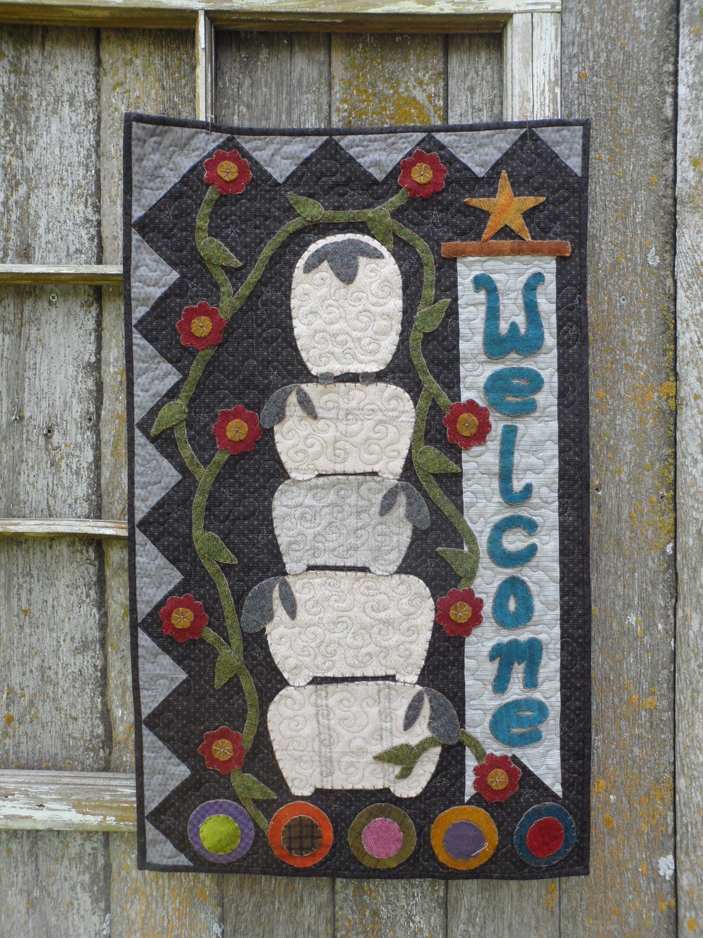 wool applique on fabric wall hanging welcome with sheep