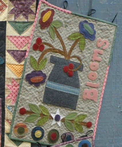 Wool applique on fabric wall hanging quilt pattern